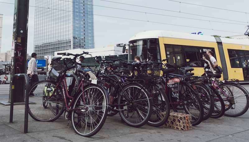 A large crowd of parked bicycles