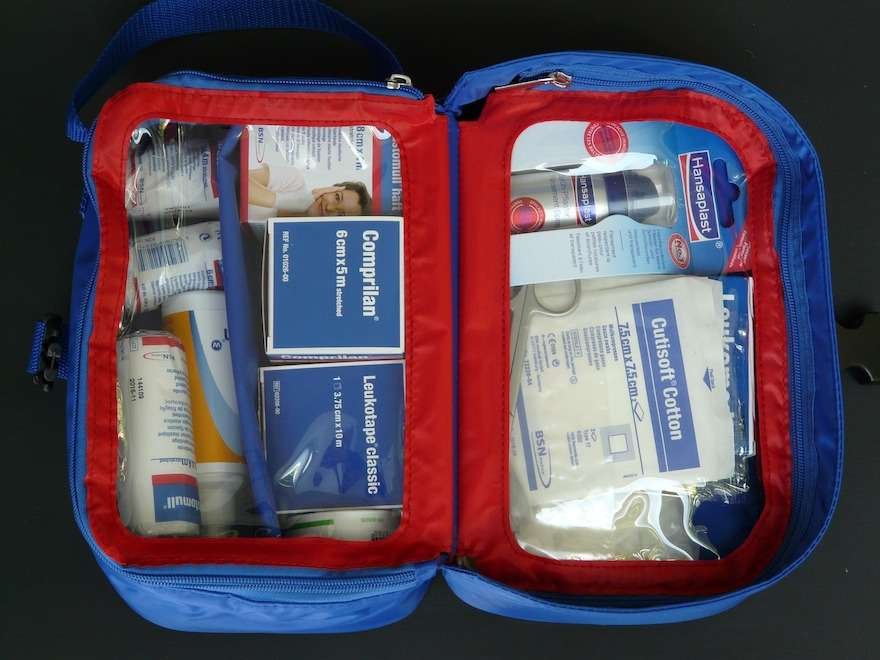 A Lightweight Bike Touring Gear List A first aid kit opened on a counter