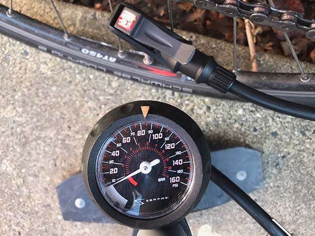 Learn how to pump a bike tire with a tire pressure gauge on a bike pump