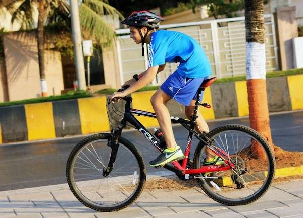 Teenage boy hunched over with poor bike ergonomics