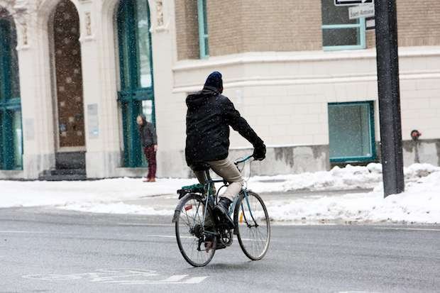 Cyclist crossing a road with fenders on his bike