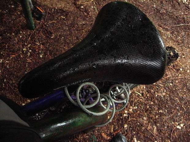 The Best Ways to Get Water Out Of A Wet Seat A bike with a wet seat locked to a bike rack