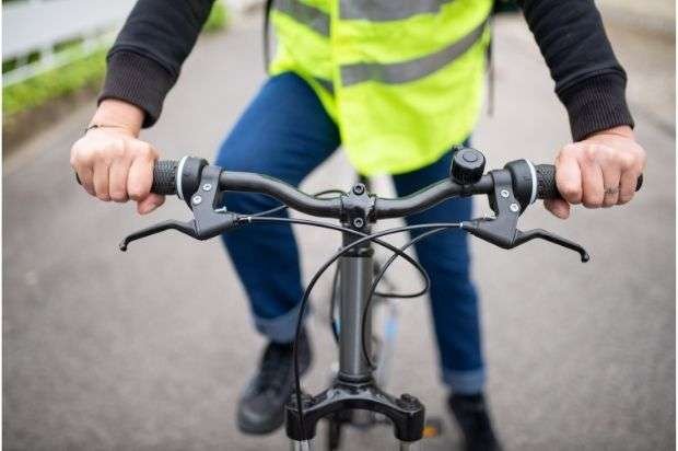 A cyclist with his hands on flat handlebars
