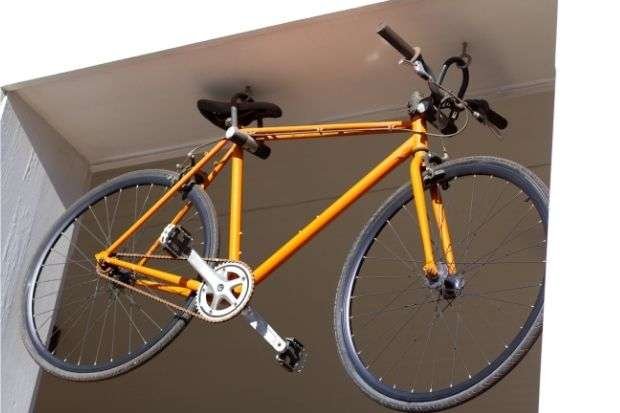 14 Easy Ways on How To Store a Bike in Small Apartments Bike hanging from ceiling after owner learned how to store a bike in an apartment