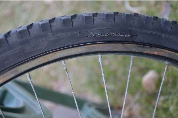 Damaged bicycle tire as a sign for when to replace bike tires
