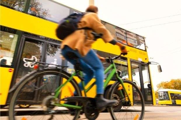 Cyclist trying to catch the bus while on a bike after researching if mountain bikes do make good commuter bikes