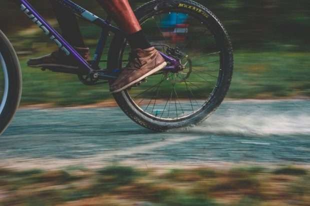 Cyclist using flat pedal shoes on bike