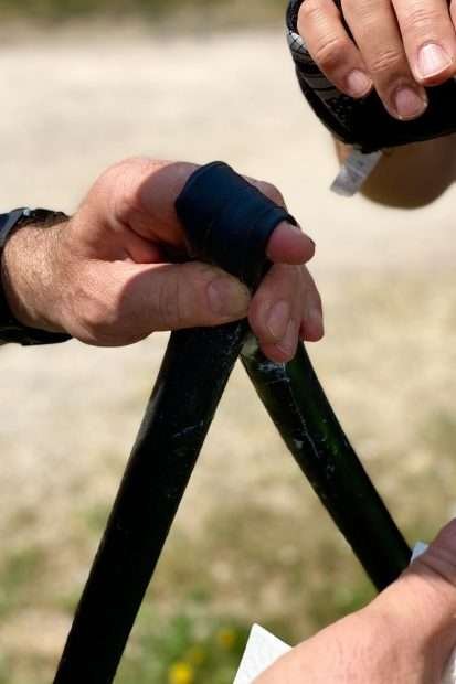 How To Carry a Spare Tube on Road Bikes: 7 Options Two men repairing spare tube for road bike